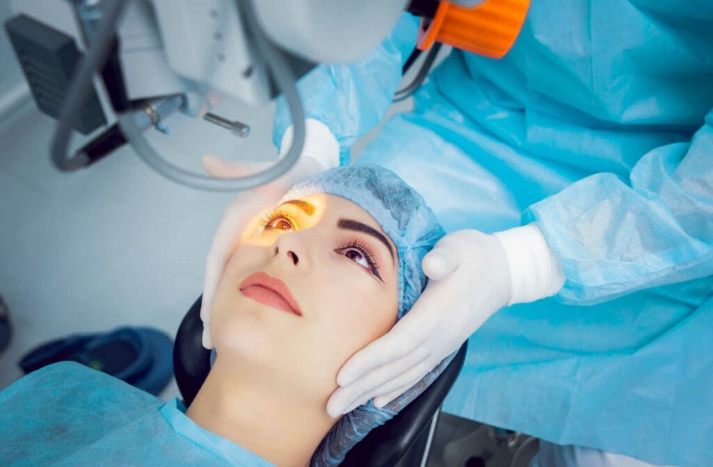 A patient ready for laser cataract surgery with their head being held by an ophthalmologist.